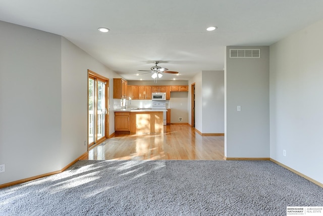 kitchen with ceiling fan, light hardwood / wood-style floors, and white appliances