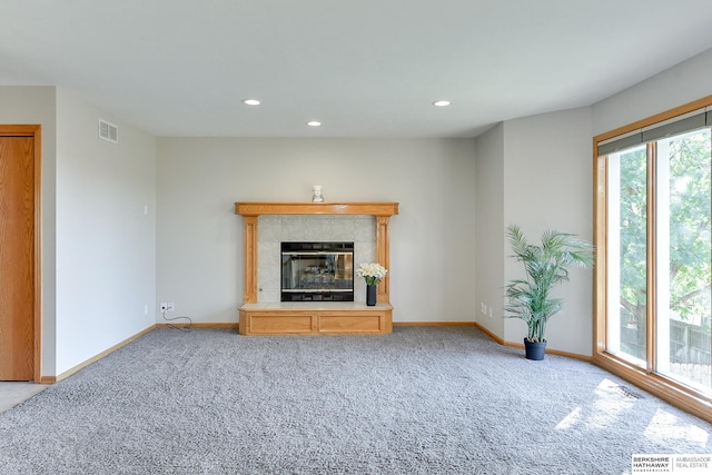 unfurnished living room with a fireplace and carpet floors