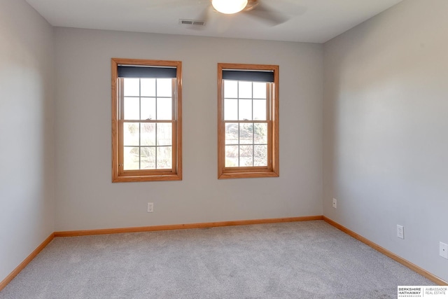 carpeted empty room featuring ceiling fan