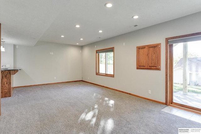 carpeted spare room with plenty of natural light