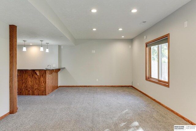 empty room with light carpet and sink