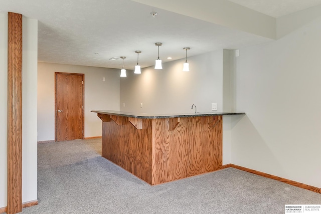 bar with pendant lighting and light colored carpet