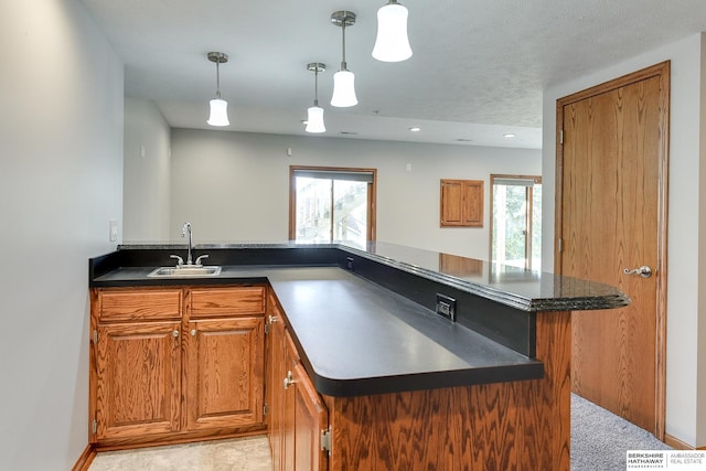 kitchen featuring plenty of natural light, a center island, sink, and hanging light fixtures