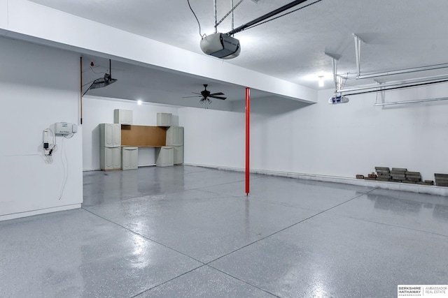 garage featuring a garage door opener and ceiling fan