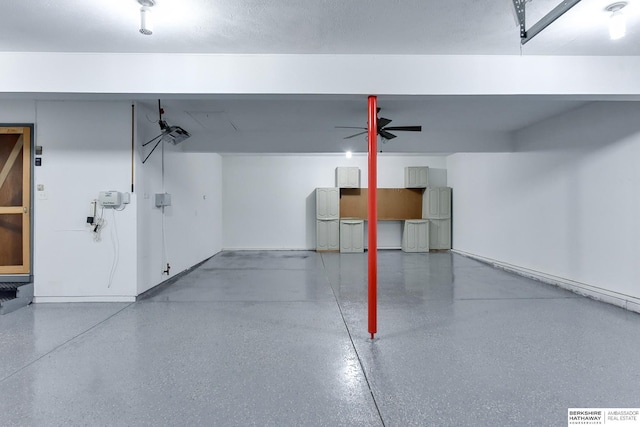 garage with a garage door opener and ceiling fan