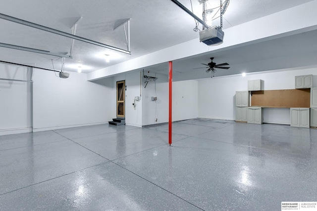 garage featuring a garage door opener and ceiling fan