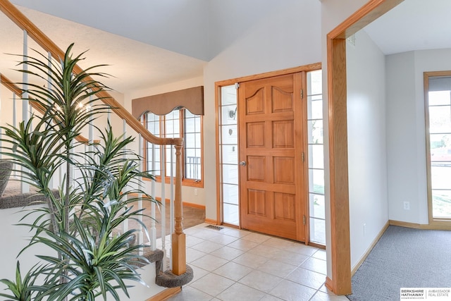 tiled foyer entrance with lofted ceiling