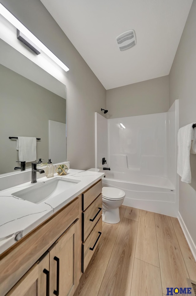 full bathroom featuring shower / bathing tub combination, vanity, and toilet