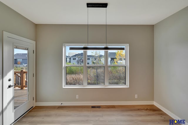 unfurnished dining area featuring light hardwood / wood-style flooring