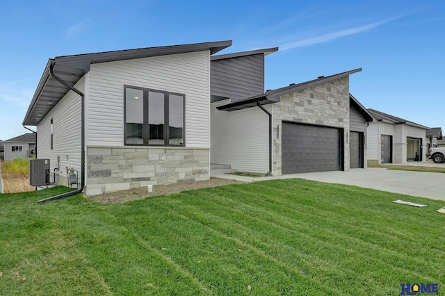 contemporary home featuring central AC, a front lawn, and a garage