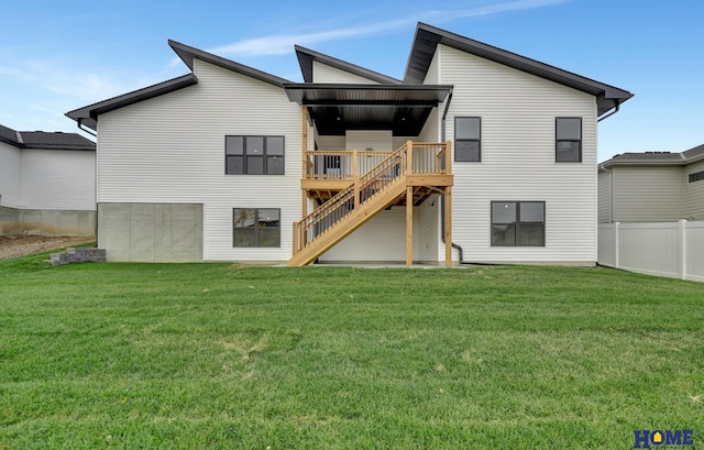 back of property featuring a yard and a wooden deck