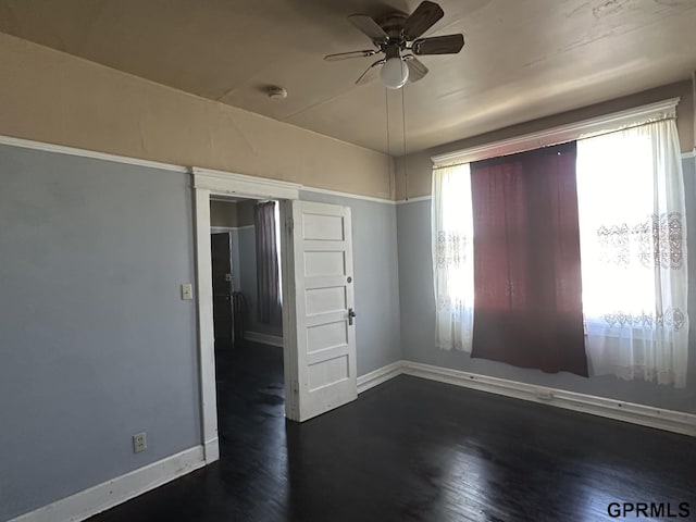 1424 4th Ave, Scottsbluff, NE 69361 - spare room featuring plenty of natural light, ceiling fan, and dark wood-type flooring