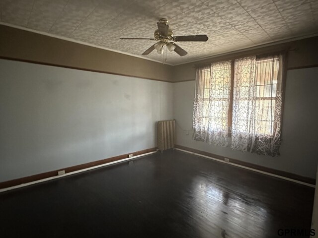 1424 4th Ave, Scottsbluff, NE 69361 - empty room with radiator heating unit, ceiling fan, ornamental molding, and wood-type flooring