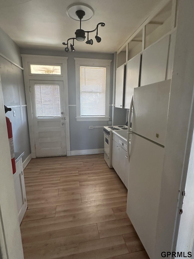 1424 4th Ave, Scottsbluff, NE 69361 - kitchen with white cabinets, white appliances, and light wood-type flooring