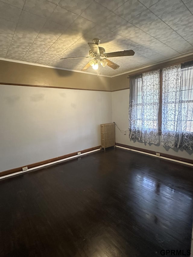 1424 4th Ave, Scottsbluff, NE 69361 - empty room with radiator, ceiling fan, crown molding, and hardwood / wood-style flooring