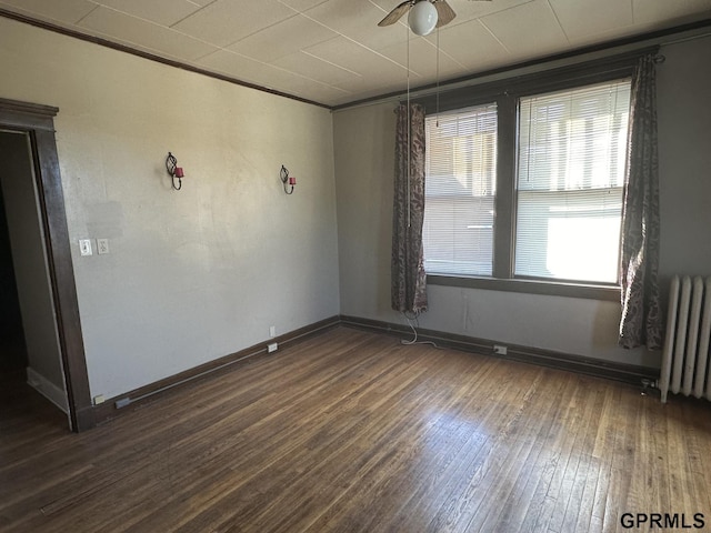 1424 4th Ave, Scottsbluff, NE 69361 - unfurnished room with radiator, ceiling fan, dark wood-type flooring, and ornamental molding