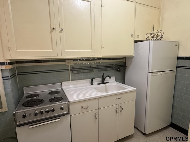1424 4th Ave, Scottsbluff, NE 69361 - kitchen with white cabinetry, sink, electric range oven, white refrigerator, and tile walls