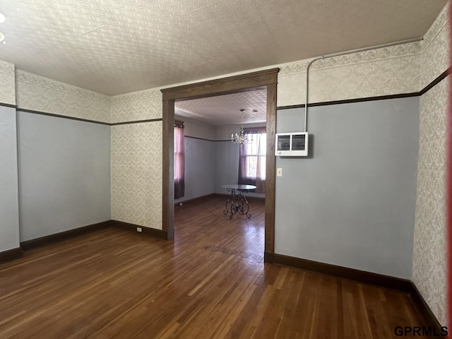 1424 4th Ave, Scottsbluff, NE 69361 - unfurnished room with dark hardwood / wood-style floors, a textured ceiling, and a chandelier