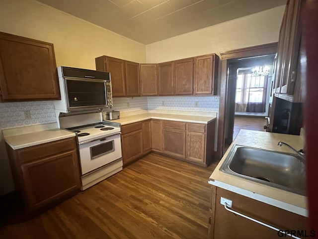 1424 4th Ave, Scottsbluff, NE 69361 - kitchen with white electric range oven, dark hardwood / wood-style flooring, sink, and tasteful backsplash