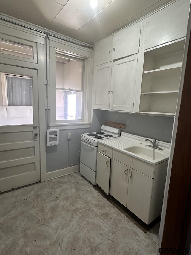 1424 4th Ave, Scottsbluff, NE 69361 - kitchen with white cabinets, white range with electric stovetop, and sink