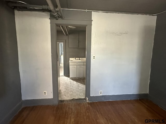 1424 4th Ave, Scottsbluff, NE 69361 - empty room featuring dark hardwood / wood-style flooring and sink