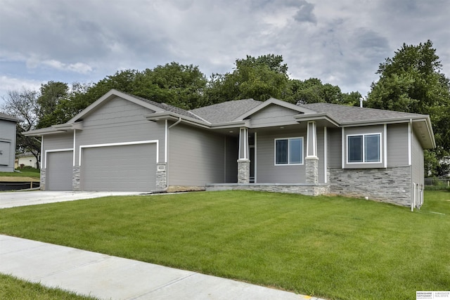 view of front of property with a front yard, a porch, and a garage