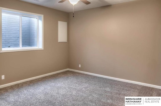 carpeted spare room featuring ceiling fan