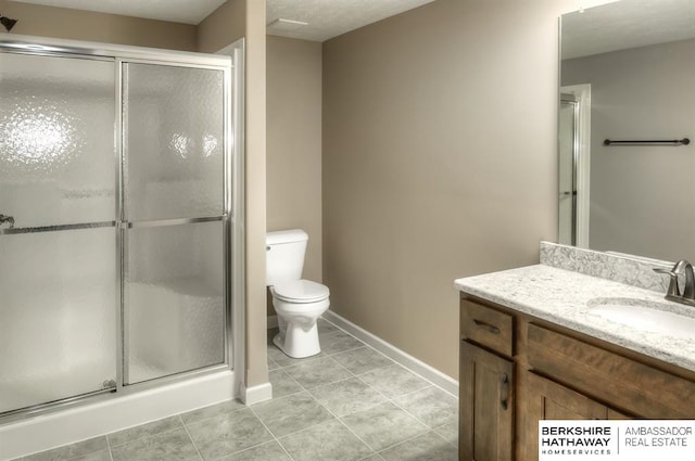 bathroom featuring toilet, vanity, tile patterned floors, and an enclosed shower