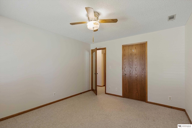 unfurnished bedroom featuring a textured ceiling and ceiling fan