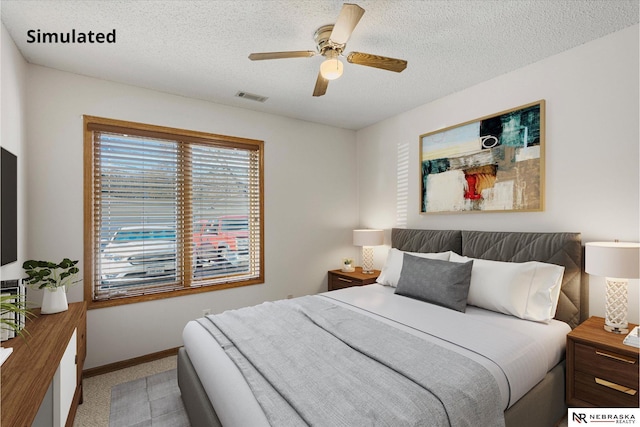 carpeted bedroom with ceiling fan and a textured ceiling