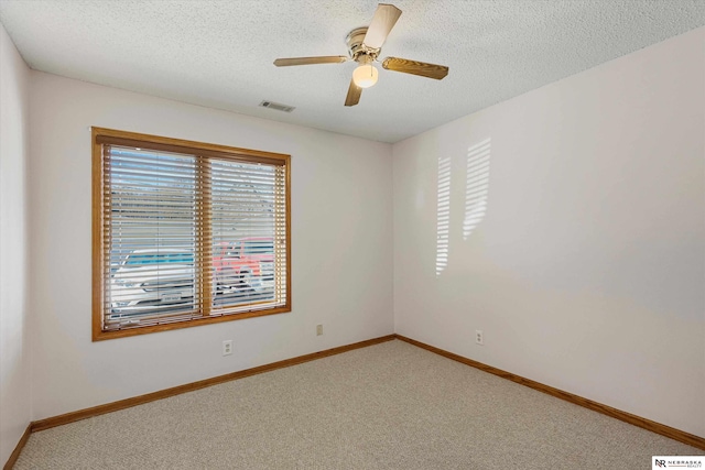 unfurnished room featuring a textured ceiling, carpet floors, and ceiling fan