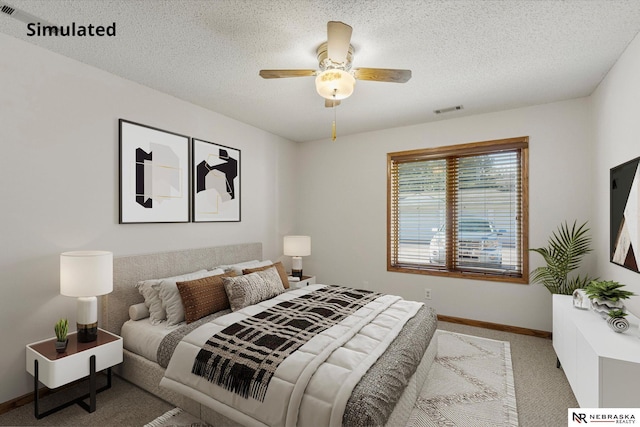 carpeted bedroom with ceiling fan and a textured ceiling