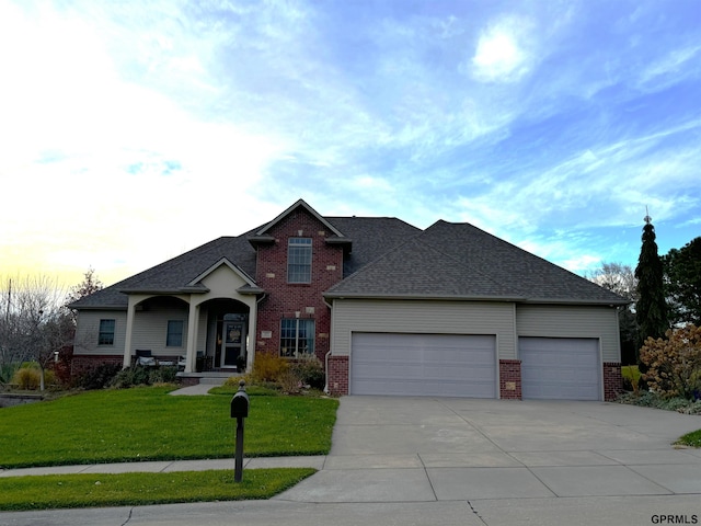 view of front of house featuring a lawn, covered porch, and a garage