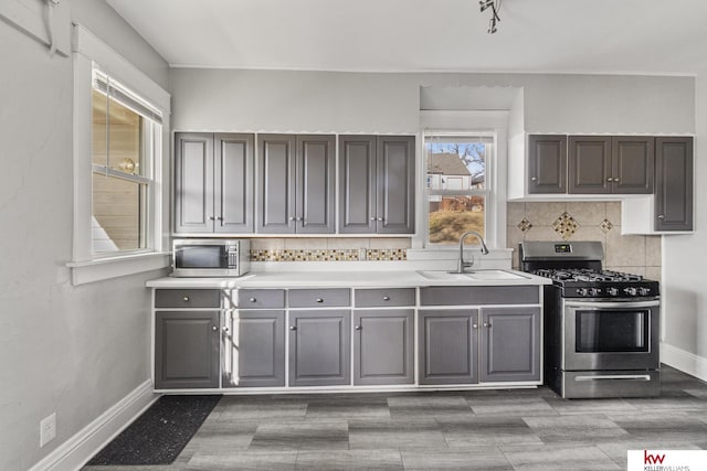 kitchen with backsplash, sink, and stainless steel appliances