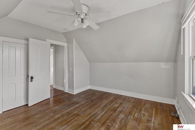 bonus room featuring ceiling fan, dark hardwood / wood-style flooring, plenty of natural light, and vaulted ceiling