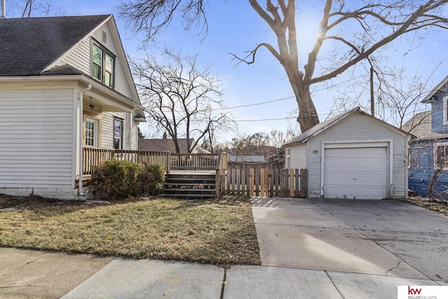 view of property exterior featuring a garage and an outbuilding