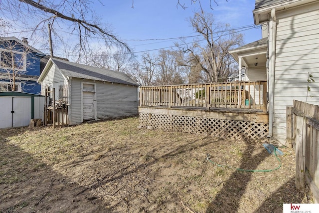 view of yard featuring a wooden deck and a shed