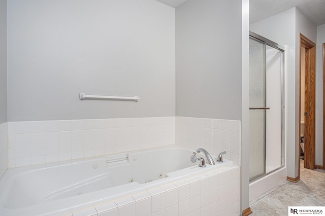 bathroom with a textured ceiling and independent shower and bath