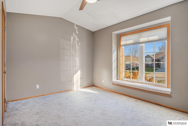 carpeted spare room with vaulted ceiling and ceiling fan