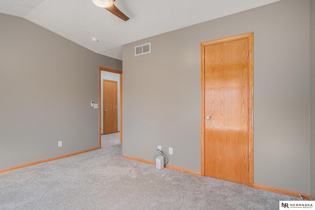 empty room with light carpet, ceiling fan, and lofted ceiling