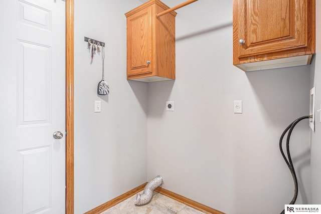 laundry room featuring hookup for an electric dryer and cabinets