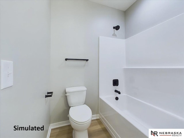 bathroom with bathing tub / shower combination, hardwood / wood-style flooring, and toilet