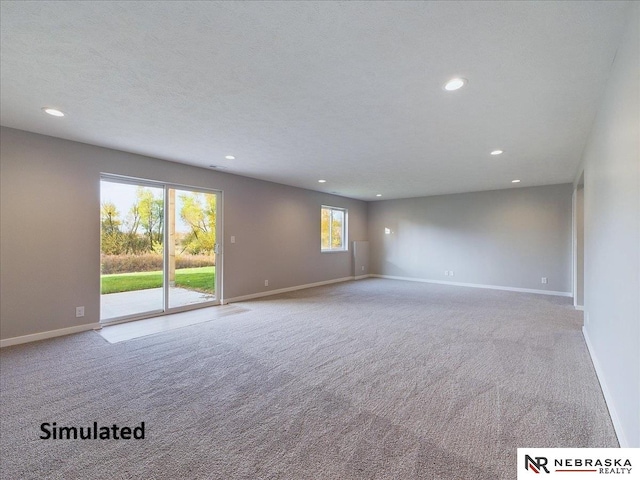 carpeted spare room featuring a textured ceiling