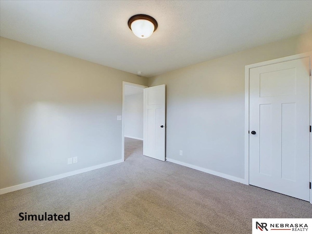 unfurnished room featuring a textured ceiling and carpet floors