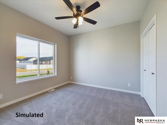 interior space featuring carpet and ceiling fan