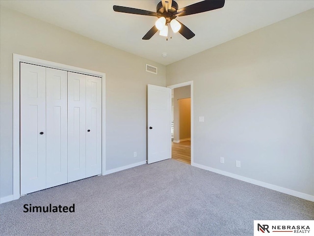 unfurnished bedroom featuring carpet, a closet, and ceiling fan