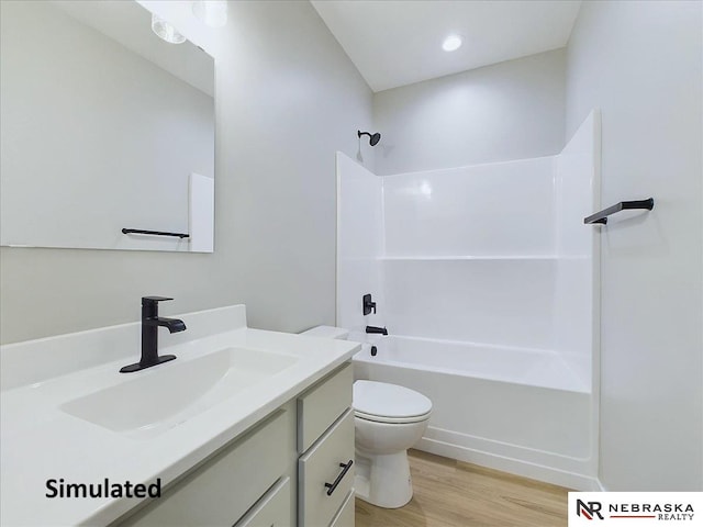 full bathroom featuring hardwood / wood-style floors, vanity, shower / bath combination, and toilet