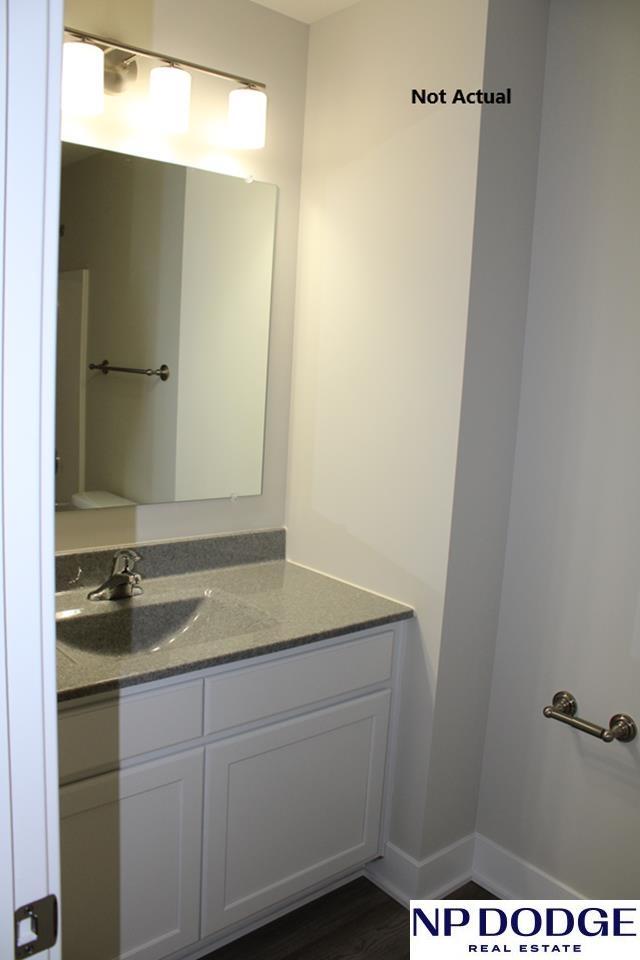 bathroom with vanity and hardwood / wood-style flooring