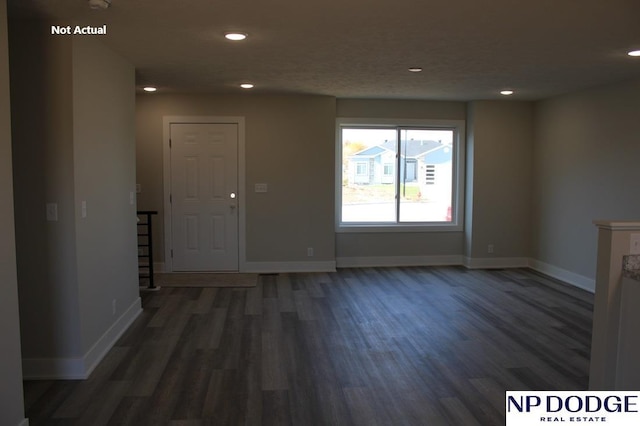 empty room featuring dark wood-type flooring