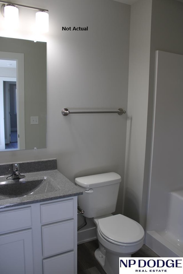 bathroom with walk in shower, vanity, and toilet